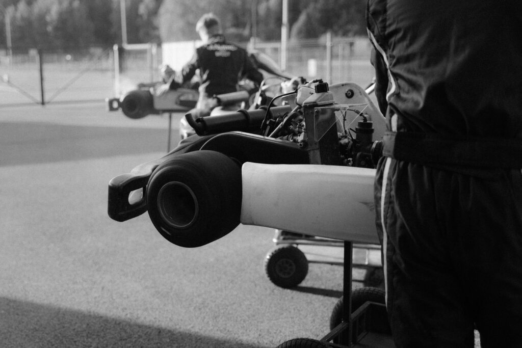 Monochrome view of racers preparing their go-karts for a competition.